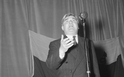 A man speaking at a microphone
