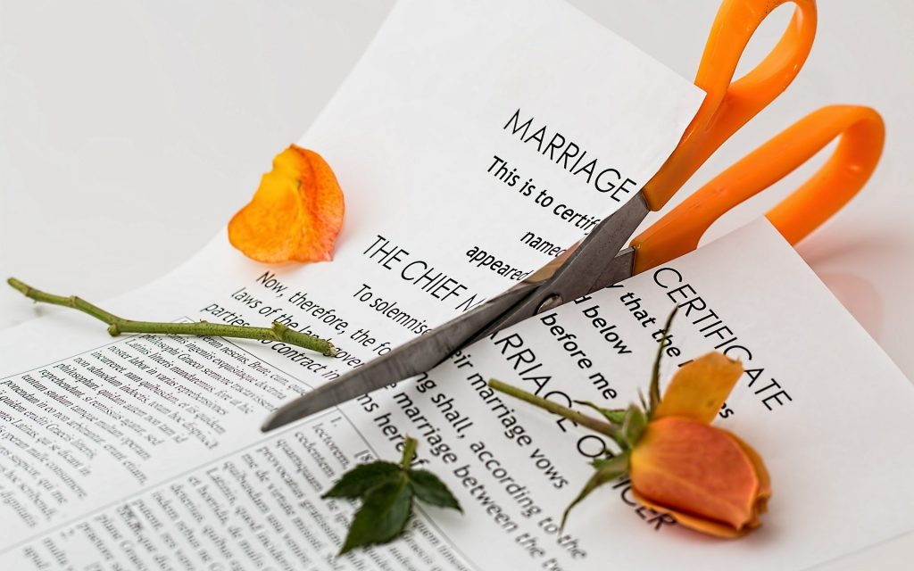 A marriage certificate being cut