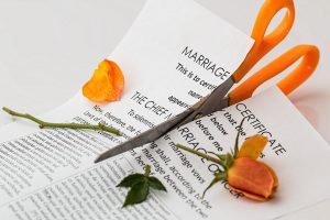 A marriage certificate being cut