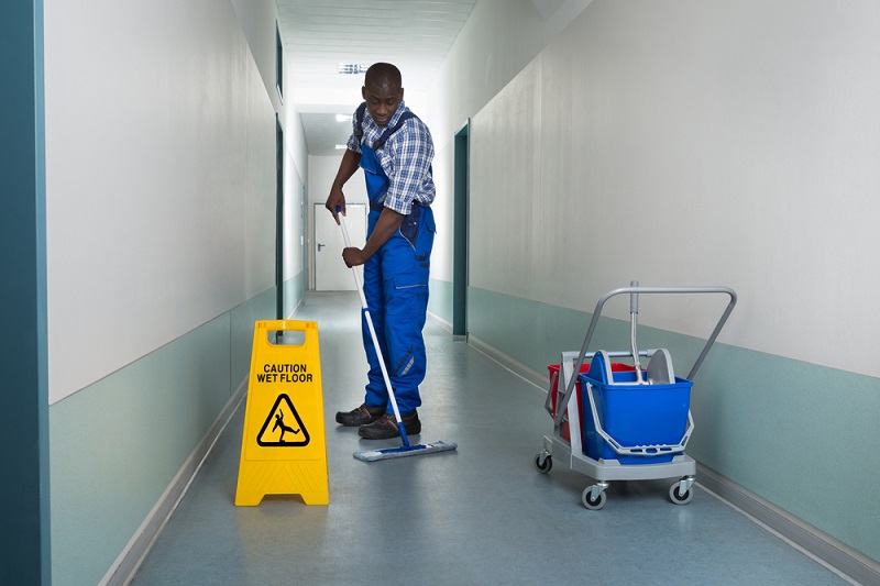 A man cleaning a floor