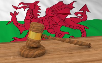 A gavel in front of a welsh flag
