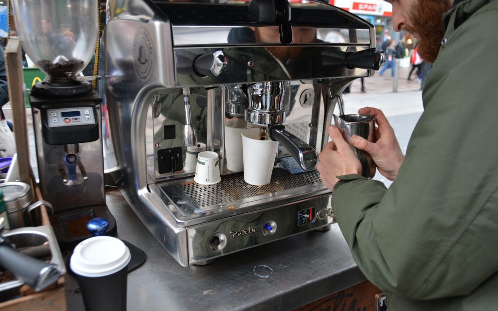 A man working at a coffee machine