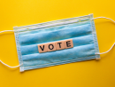 A face mask with the word vote