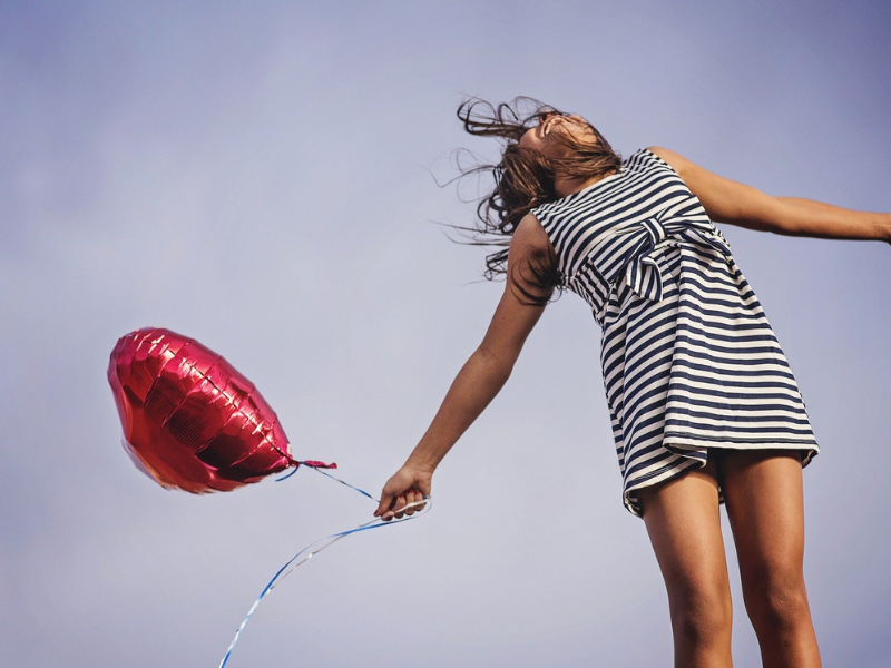 A girl holding a balloon