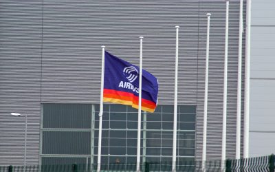 A flag saying airbus outside a building