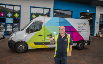 A man standing in front of a Creating Enterprise van