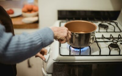Person cooking on a gas hob